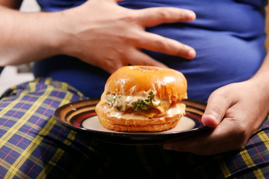 Comprehensive Metabolic Panel Explained: What Each Marker Reveals a person holding a plate with a sandwich on it